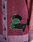 Close-up of a Alemais MLAK purple cardigan with a decorative fish patch.