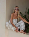 Estillo Emporio Papillion Jumpsuit - Panna White worn by model in natural setting LUXAMORE