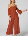 Estilo Emporio Fiorella Top - Rust - LUXAMORE -Tops-Shop the Estilo Emporio Fiorella Top in rust. Made in Positano from 100% Italian linen, this off-the-shoulder design features shirred details and fluted cuffs.
