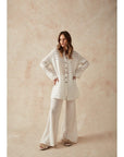 Woman Wearing Estilo Emporio Novo Flare Pant - Brasile Panna White - Pants LUXAMORE