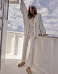 Woman Wearing Estilo Emporio Novo Flare Pant - Brasile Panna White - Pants LUXAMORE