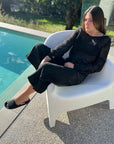 Estilo Emporio Stevie Top - Black worn by model in natural setting LUXAMORE