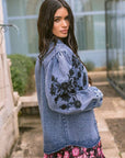 Floral Cosmos Denim Boho Embroidered Overshirt worn by model in natural setting LUXAMORE