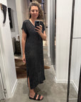 Woman taking a mirror selfie wearing a la bottega di brunella linen dress made in italy in a room.