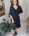 Woman Wearing Linen Dress V-neck Knot Front Midi Made in Italy Black - Dress LUXAMORE