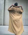 Linen Dress Oversize Maxi Kaftan Made in Italy Caramel worn by model in natural setting LUXAMORE