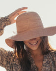 Made in Mada Desire Hat - LUXAMORE -hat-The ELYA hat is the handmade summer hat that compliments your outfit from Made in Mada. Hand woven and dyed – double crochet- adjustable size – inner cotton band for comfort – wire to adjust the brim Beautifully weaved in Madagascar and designed in Australia Weave time 2.5 days Material - Raffia. Cotton & wire Keep your item dry – stain treatment – blot the stain with warm or tepid water and dry.