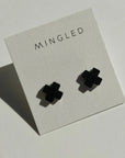 Mingled Black Cross Stud Earrings - Small Cross Earrings, Minimalist worn by model in natural setting LUXAMORE