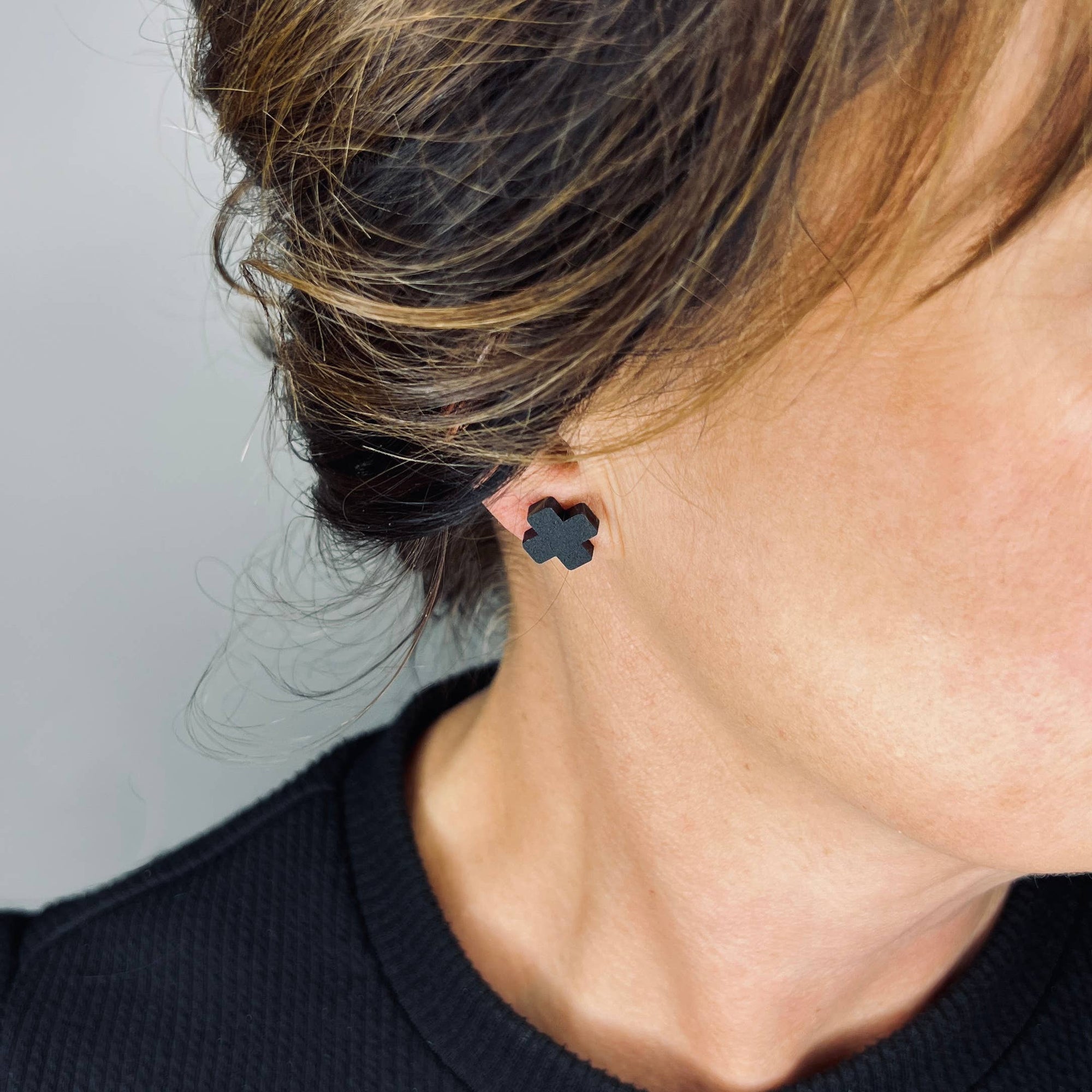 Woman Wearing Mingled Black Cross Stud Earrings - Small Cross Earrings, Minimalist - Earings LUXAMORE