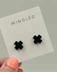 Mingled Black Cross Stud Earrings - Small Cross Earrings, Minimalist worn by model in natural setting LUXAMORE