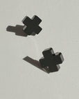 Mingled Black Cross Stud Earrings - Small Cross Earrings, Minimalist worn by model in natural setting LUXAMORE