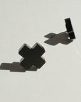 Mingled Black Cross Stud Earrings - Small Cross Earrings, Minimalist worn by model in natural setting LUXAMORE