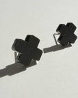 Mingled Black Cross Stud Earrings - Small Cross Earrings, Minimalist worn by model in natural setting LUXAMORE