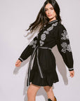 Verona Black & White Short Boho Embroidered Dress worn by model in natural setting LUXAMORE