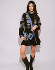Verona Black & White Short Boho Embroidered Dress worn by model in natural setting LUXAMORE