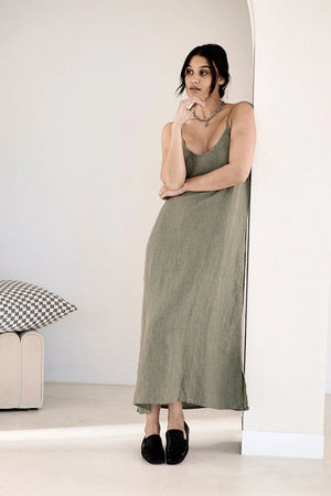 Soft, stylish linen dress with an elasticized back and adjustable straps, designed for relaxed elegance and all-day comfort.