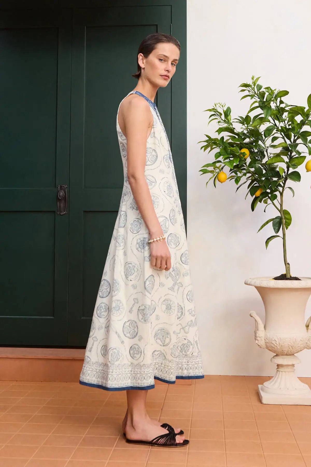 Premium European linen midi: ALÉMAIS Lucky Lace Up Midi Dress in ivory white linen featuring an elegant high neck design.. LUXAMORE