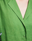 Premium resort-wear dress: Close-up of the self-covered buttons and fine line work on the ALÉMAIS Nanci dress.. LUXAMORE