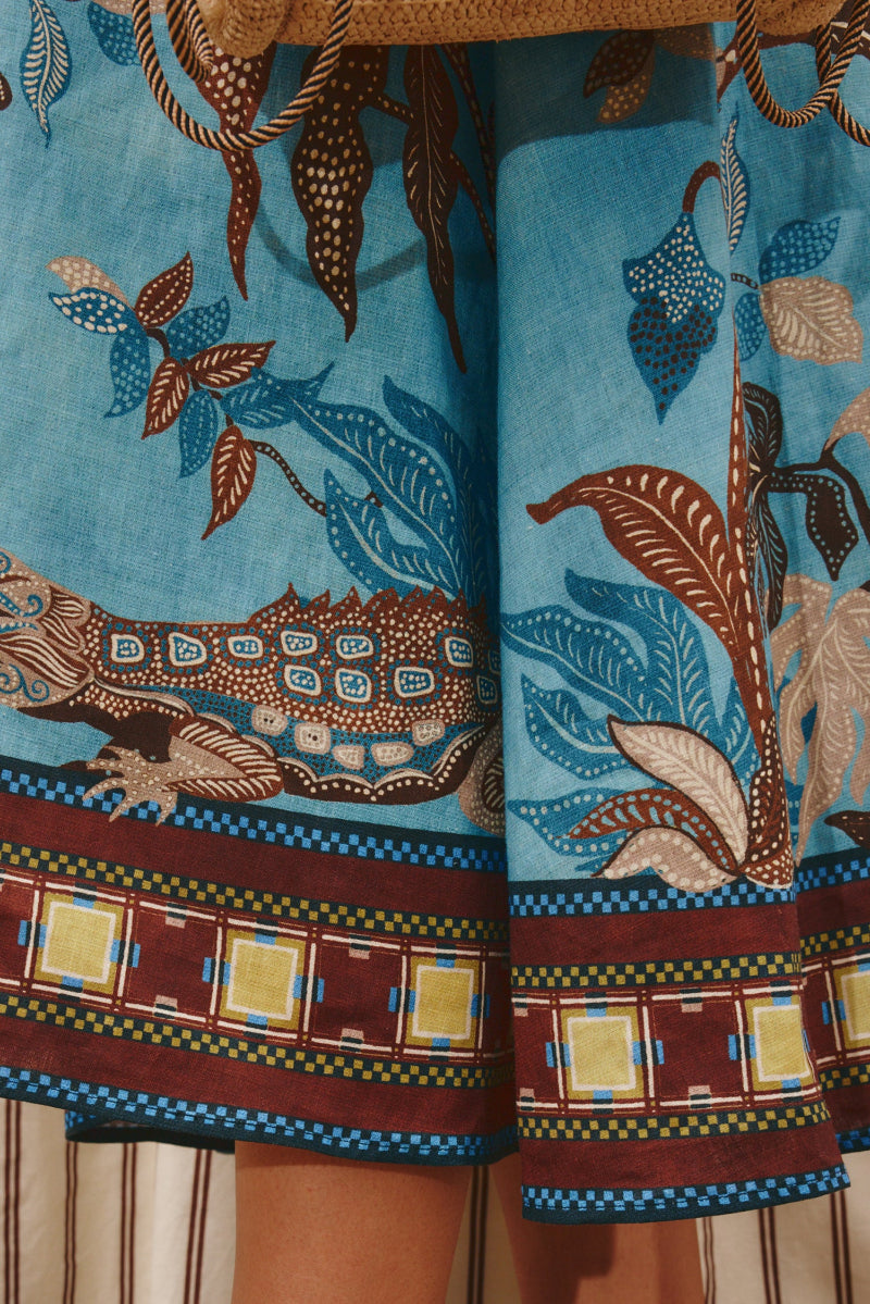 Traditional patterned fabric with lizard design on a blue background