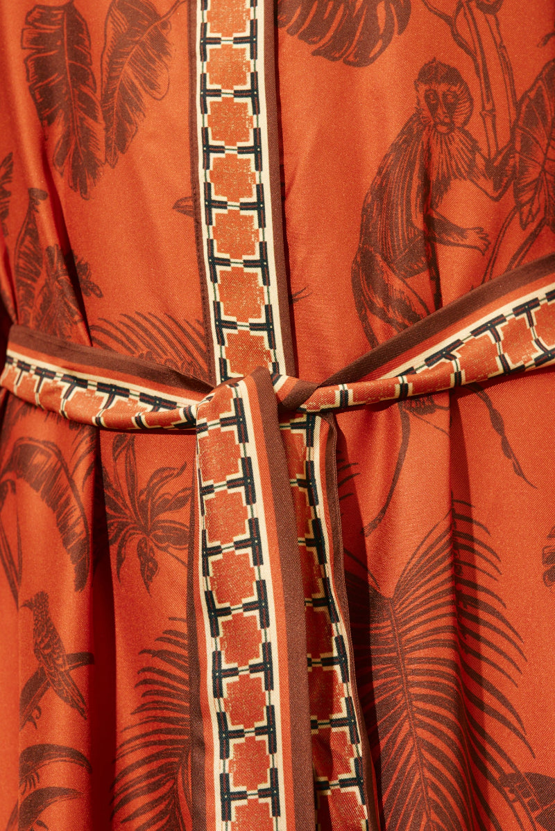 Orange fabric with black leaf and bird pattern