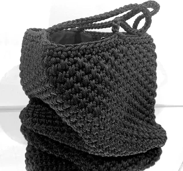 CDC Crochet Bag - Black worn by model in natural setting LUXAMORE 
