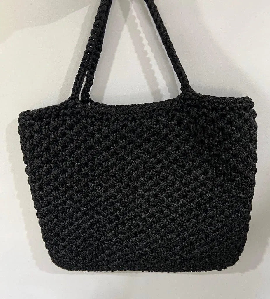 CDC Crochet Bag - Black worn by model in natural setting LUXAMORE 