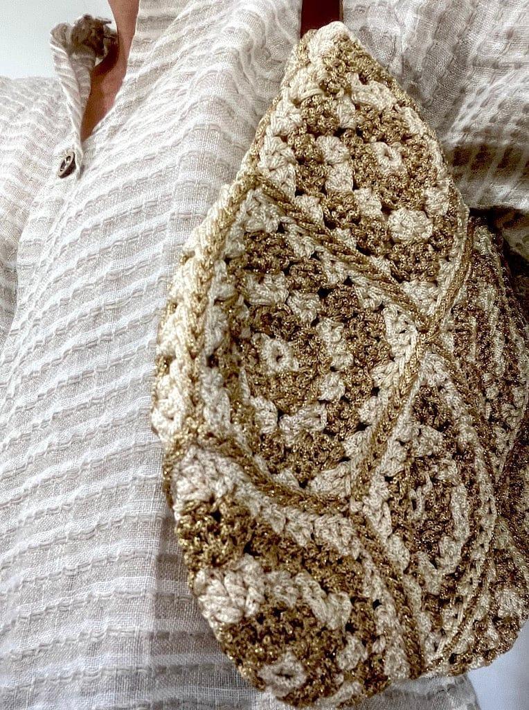 Crochet Bag - Gold worn by model in natural setting LUXAMORE 