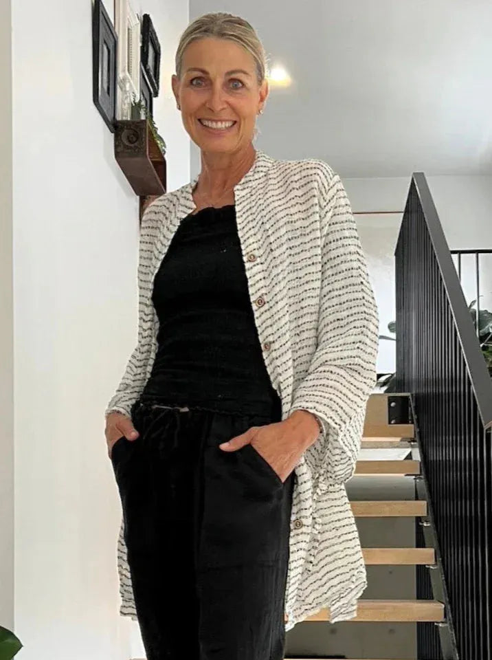 Estilo Emoporio Manta Mini Linen Dress worn by model in natural setting LUXAMORE 