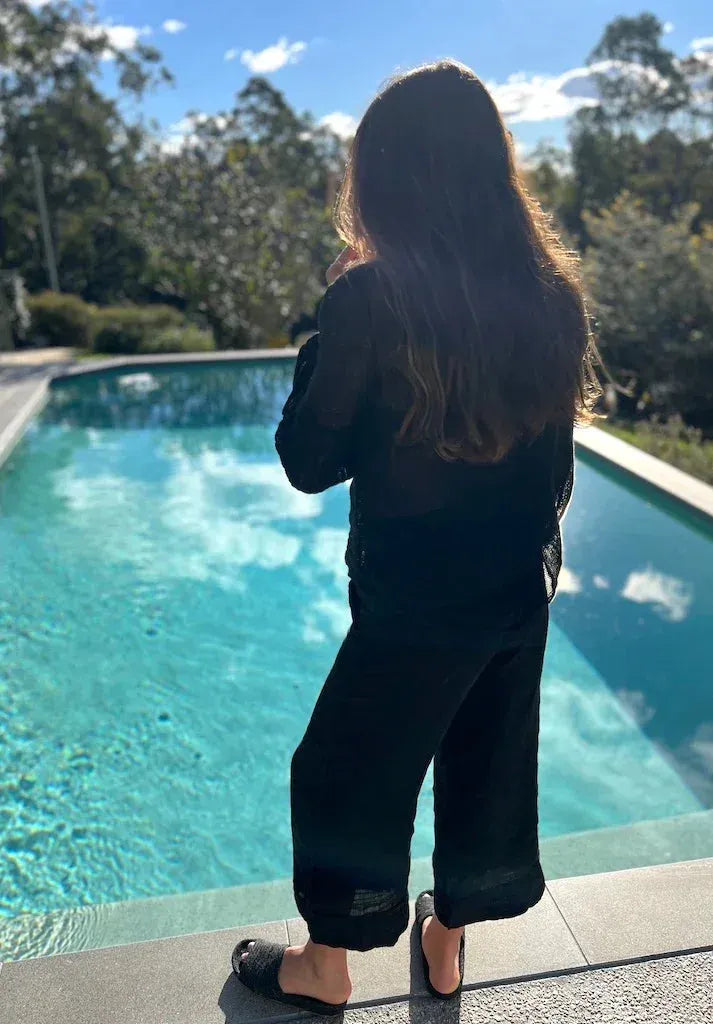 Estilo Emporio Stevie Top - Black worn by model in natural setting LUXAMORE 