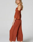 Estilo Emporio Linen Pant Tropez - Rust worn by model in natural setting LUXAMORE 