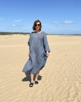 womon walking on sand in la bottega di brunella fausta dress