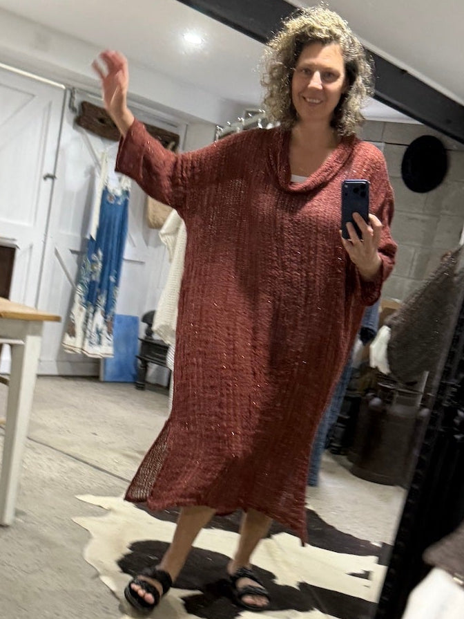 Person taking a mirror selfie wearing a la bottega di brunella linen dress in a room with a large mirror.