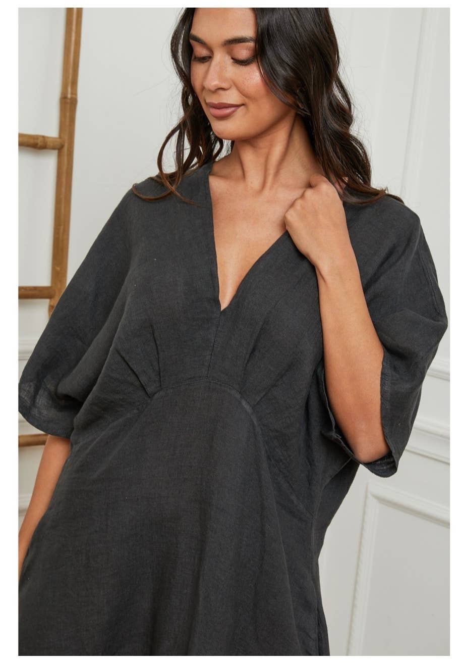 Woman wearing a dark gray dress with a blurred background