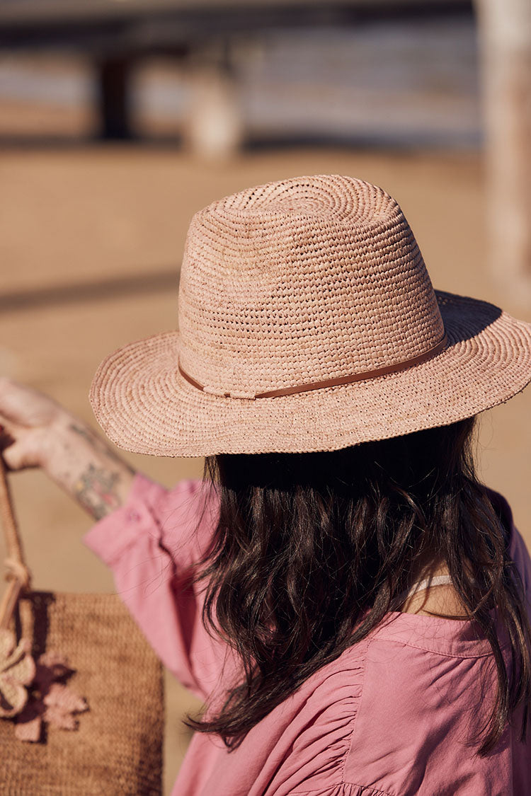 Person wearing Made in Mada Hat ELYA TAN LEATHER linen dress LUXAMORE 