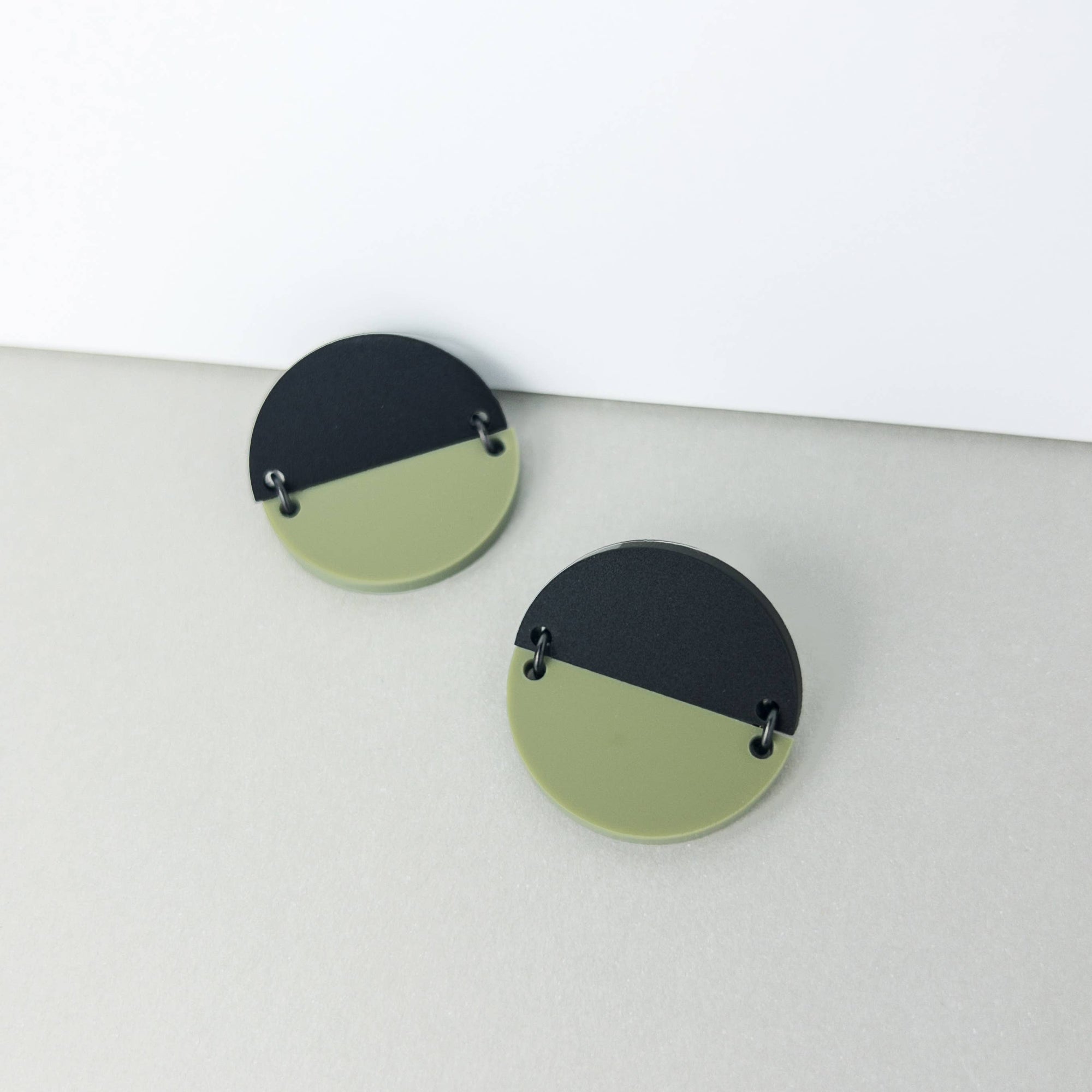 Mingled Statement Studs in Olive Green and Black - LUXAMORE --The TWO PIECE Statement Studs in Black and Olive Green are the perfect modern minimalist earrings. The geometric, large round half discs are joined with high quality black coated stainless steel jump rings Studs. Handmade in Australia with surgical steel hypoallergenic posts making them perfect for sensitive ears. Made from highly durable acrylic, these earrings are super lightweight, you won't even know you are wearing them.
