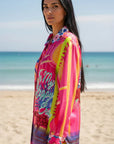 Wide-leg 7/8 trousers: Miss Goodlife Pants Sunset Dream in an all-over multicolor print with button and collar LUXAMORE
