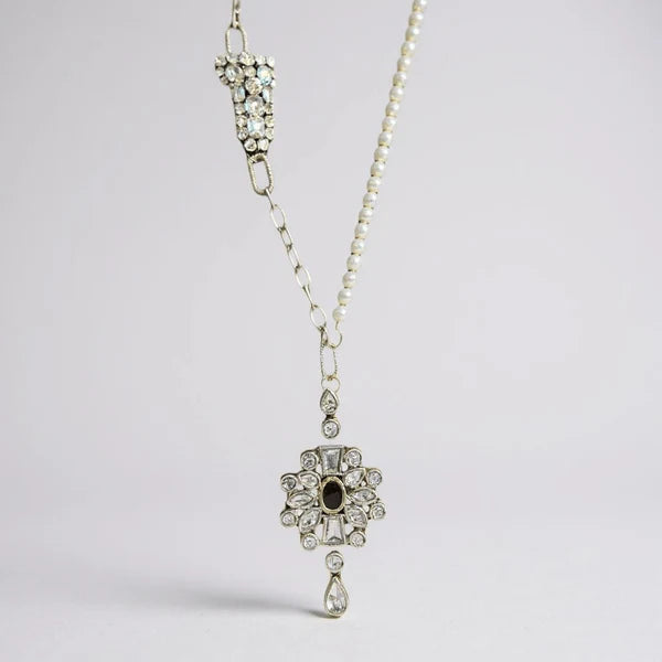 Orna Curio Vintage Bespoke Pearl and Diwali Flower Necklace - LUXAMORE -necklace-One of a Kind – Hand-crafted Necklace This elegant necklace features a vintage diamante crystal element, complemented by a sterling silver chain and fittings, with a vintage gold-plated garnet Indian floral centrepiece. This one of one necklace was handcrafted in Perth, WA. Measurements: 61cm Adjustable Materials: Sterling Silver 925 Chain and Hardware, Freshwater Pearls, Vintage Indian garnet and crystal Centrepiece.