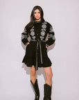 Verona Black & White Short Boho Embroidered Dress worn by model in natural setting LUXAMORE 